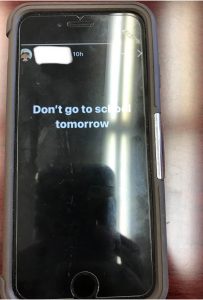 iPhone showing Instagram Story black background with "Don't go to school tomorrow" in white text