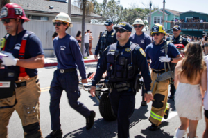 Fire and Law Enforcement personnel walking through a crowd